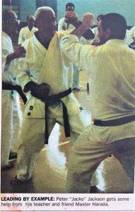 Newspaper article, text reads leading by example: Peter Jackson gets some help from his teacher and friend Master Harada. Image shows Peter blocking a punch helped by Master Harada